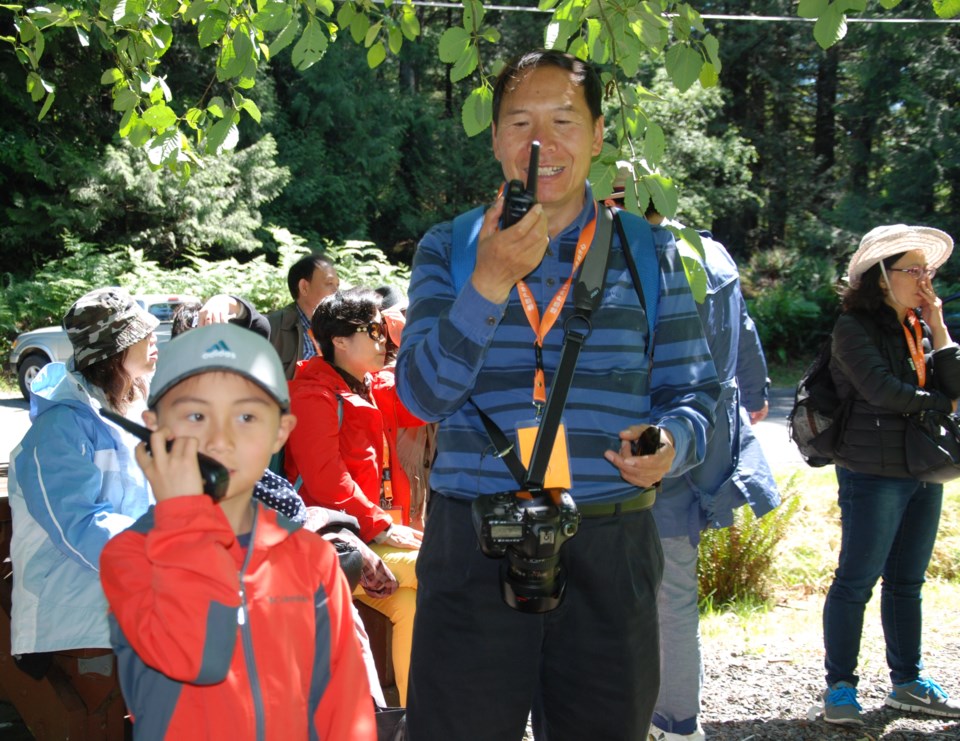 Hikers from the Yoyo Hiking Club test their walkie-talkies in Crippen Park.