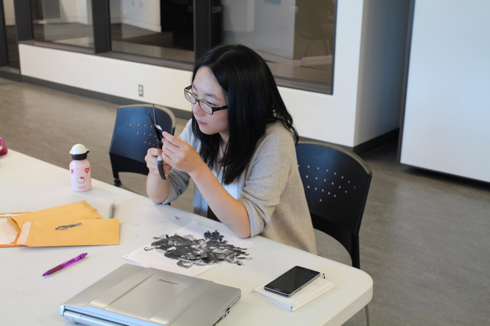 Cherry Lu works on her contribution to the Living Archive exhibition at the New Westminster Museum.