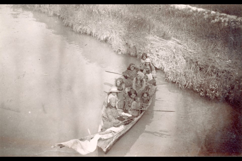 Women and children in a dugout canoe on the Fraser River in 1890. Sloughs offered perfect campsites for families. City of Vancouver archives.