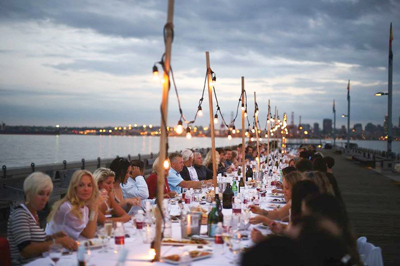 Guests enjoy a unique dining experience at last year's Dinner on the Pier. The tables will be twice as long this year for the 2016 dinner scheduled for Aug. 4. photo Matt Bourne