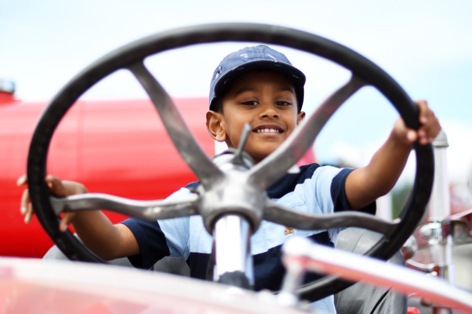 Four-year-old Aarav Tatapudi tries out a New Westminster Fire Department truck.