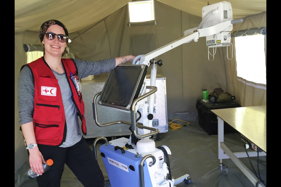 Burnaby X-ray technologist and recent SFU health sciences grad Lauren Shandley poses by a mobile X-ray machine during training with the Canadian Red Cross outside of Toronto earlier this month.