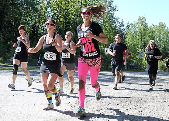 Competitors in the Spartan Race obstacle course at Inter River Park tackle flames, mud , climbing, trail running and "Spartan Warriors" at the finish line.