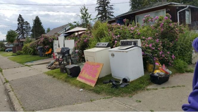 Council is recommending remedial action on this Spruce Street home. Garbage litters the front yard backyard, this June 8 image shows.