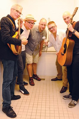 Members of Spirit of the West clown around backstage.