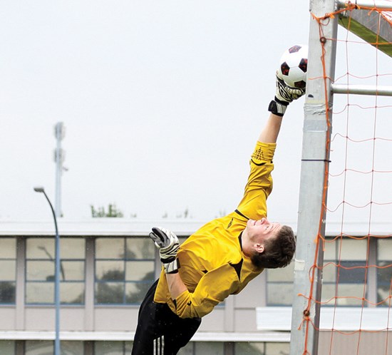 A goalkeeper makes an acrobatic save during last year’s Les Sinnott Boys Memorial Cup. The provincial championship tournament will be played in West Van this year.