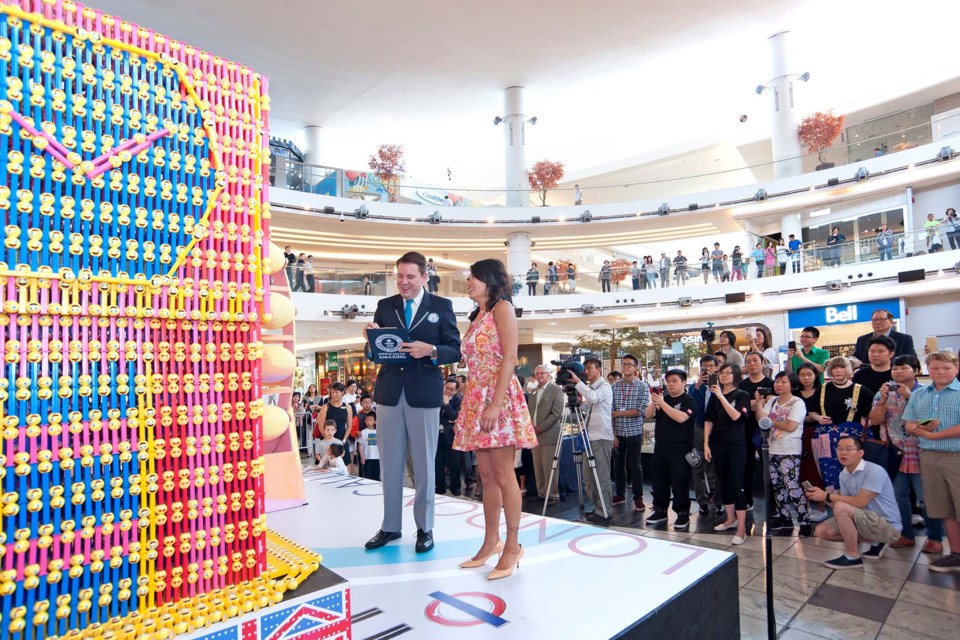 A Guinness Book of Records representative, left, measures 'Big Ben' prior to proclaiming the world record, along with Aberdeen Centre's Joey Kwan