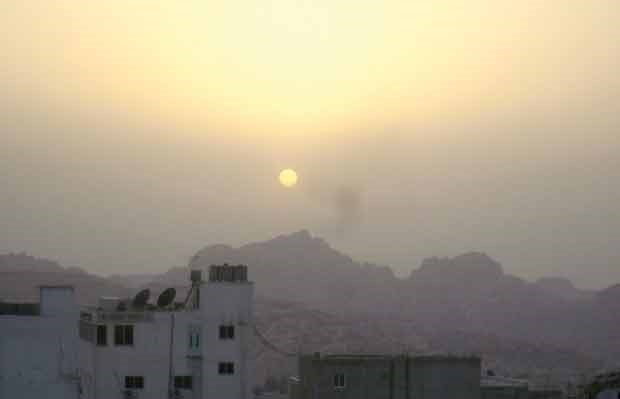 The sun sets over Wadi Musa, a modern city outside Petra.