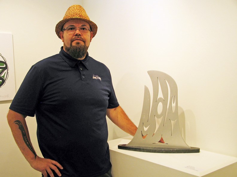 Jody Broomfield, Coast Salish artist, with his aluminum sculpture.