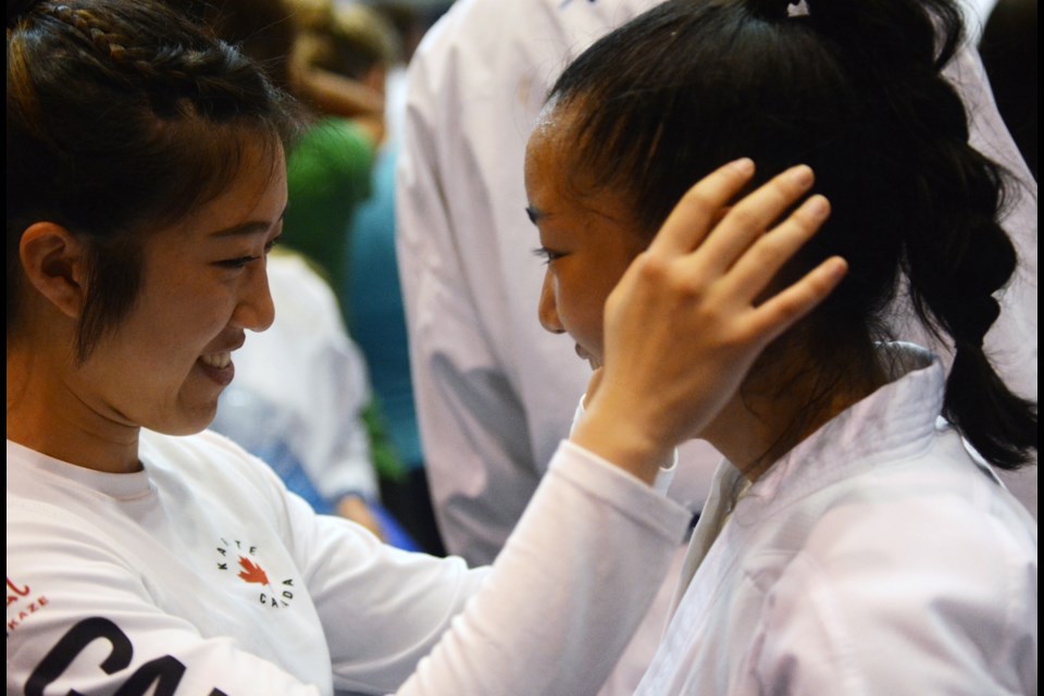 Team Canada's Isabel Chan, at left, congratulates cousin Melissa Chan after the latter's decisive win in the -48-kilogram girls 16-to-17 division at the Youth World Cup in Umag, Croatia.
