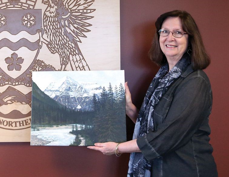 Laura Chandler stands with a piece of her artwork at city hall, in this Feb. 29 file photo.