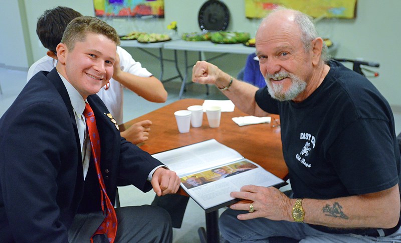 Former boxer Tommy Boyce takes a fake swing at St. George’s School Grade 10 student Daniel Teperson during a wrap-up tea for an inter-generational storytelling project at Burnaby's Poppy Residences last month.