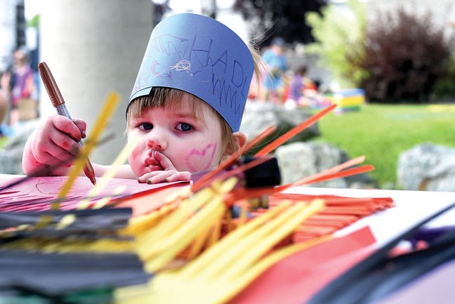 Hadley Lewis, 2, decorates a crazy hat at Two Rivers Gallery BMO KidzArt Dayz Friday. Citizen photo by Brent Braaten July 8 2016
