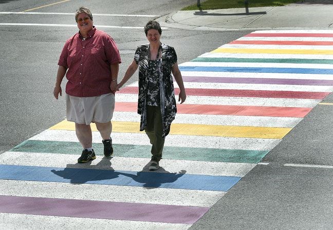 Wendy Young and Theresa Healy use the pride walk on Seventh Avenue on Friday afternoon.