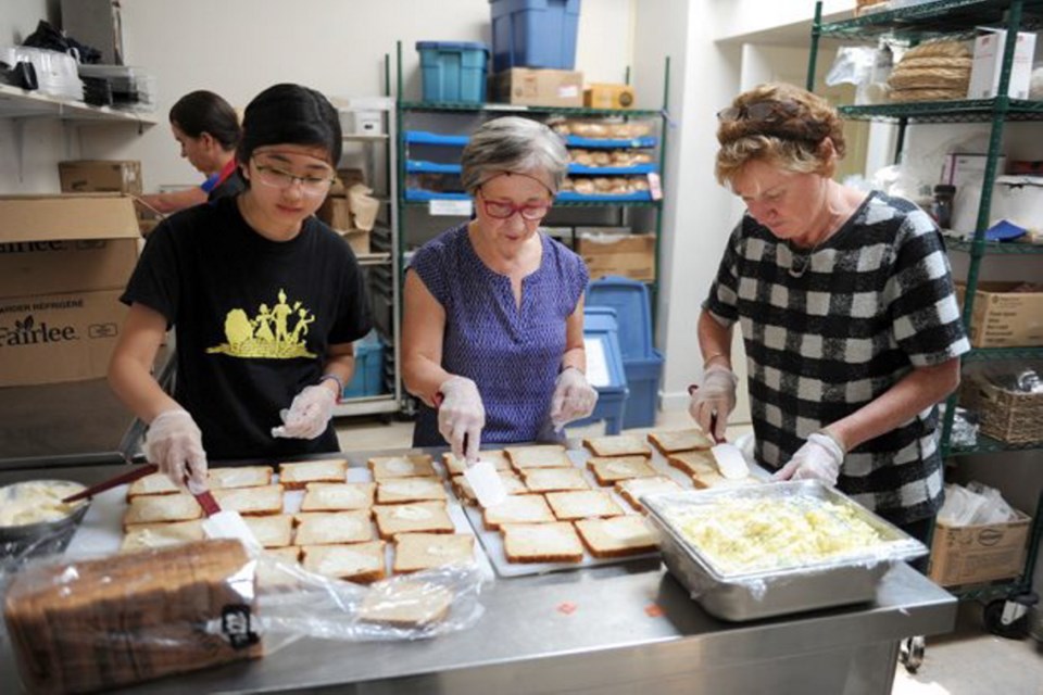 Clockwise from above: Volunteers prepare lunches for underprivileged kids at summer camp as part of the Feeding Our Future program.