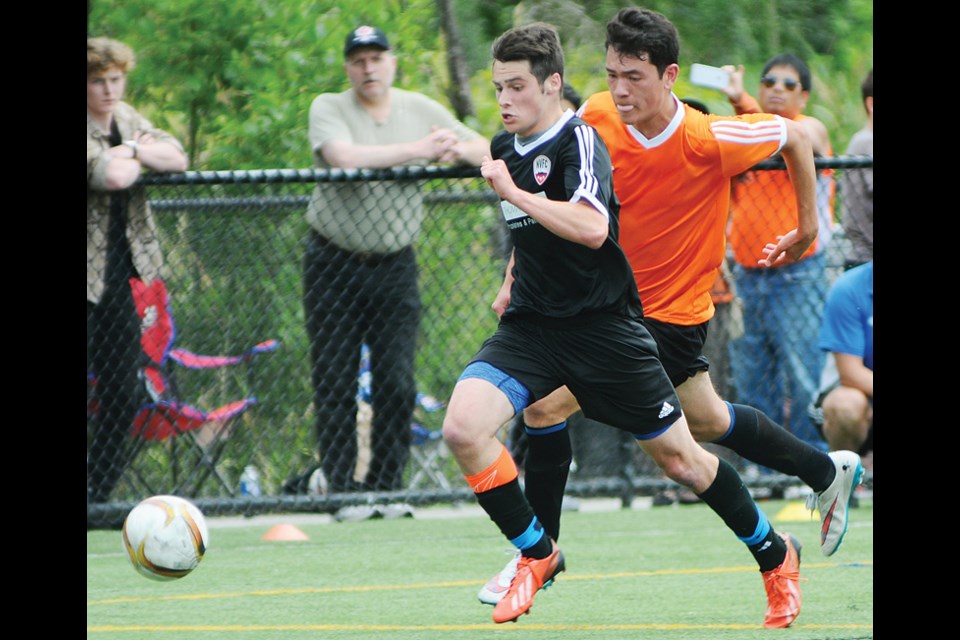 Alec Craven of the North Van FC Fury pulls away from a defender from Westminster United during a 3-1 win in the final of the Les Sinnott Memorial Boys Provincial Cup played Sunday at Ambleside Park. photo by Cindy Goodman, North Shore News