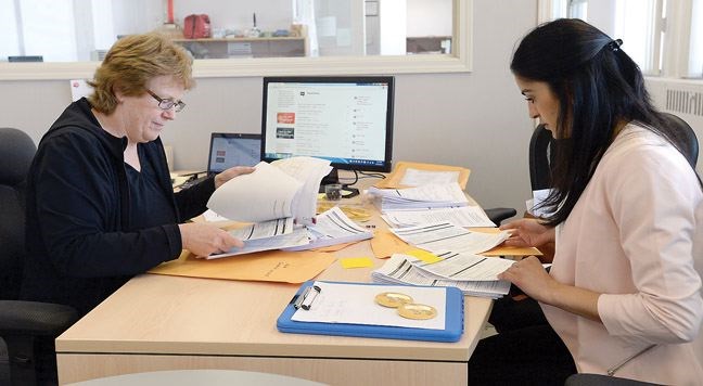 Kerry Pateman, count coordinator and Ashley Thandi go through the surveys taken during the national point-in-time survey in April. Prince George's results were released this week. Citizen photo by Brent Braaten   April 19 2016