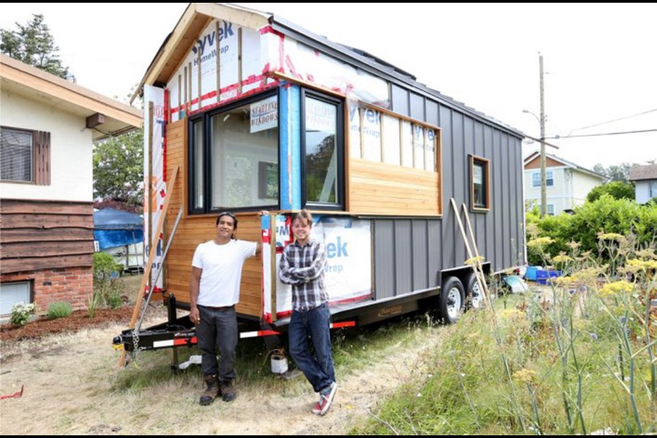 Ryerson University architecture students Gregorio Jimenez, left, and Douglas Peterson-Hui in front of their tiny house on wheels.