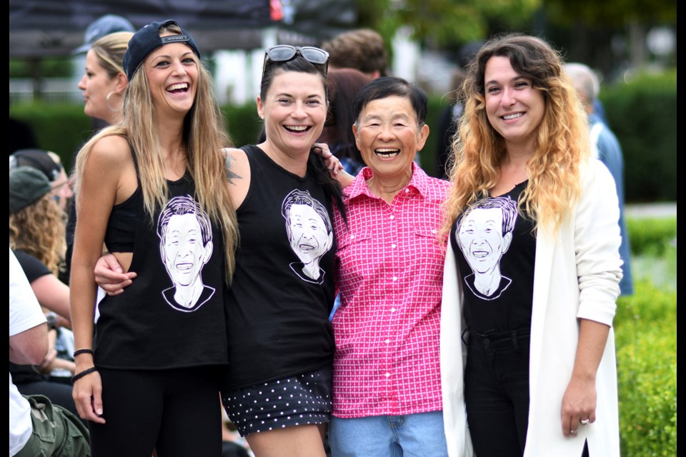 Monica Adey, Lynn McQuigge and Amy Byers pose with Joyce Wong while wearing T-shirts that bear her face. Photo Jennifer Gauthier