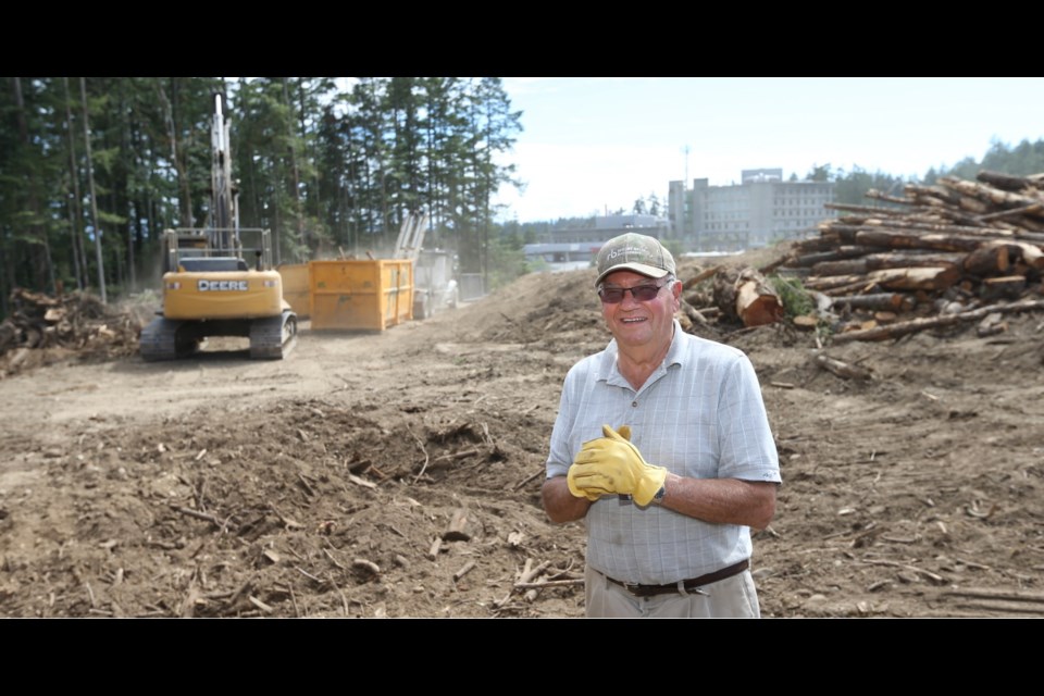 Landowner Allen Vandekerkhove, 80, on his Watkiss Way property in July 2016, with Victoria General Hospital in the background. Last year, he logged 4,900 trees to make way for hay after Saanich shunned his site for a proposed sewage-treatment plant.