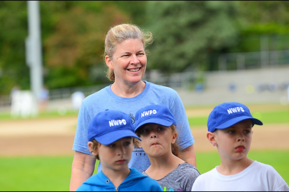 Veteran coach Const. Arloa Popke herds a group of campers during the New Westminster Police Department's soccer school Wednesday.