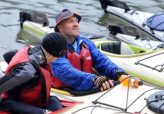Racers get in their kayaks.