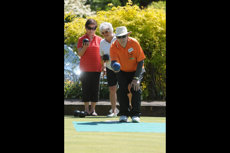 New Westminster Lawn Bowling Club coach Robert Ascroft gives pointers to Marta Nykl and Marietta Arciaga at the club’s open house.