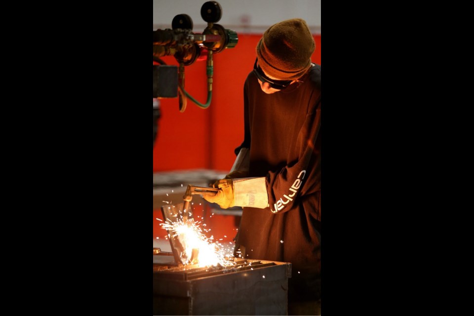 A welding apprentice practises his trade at Camosun College.