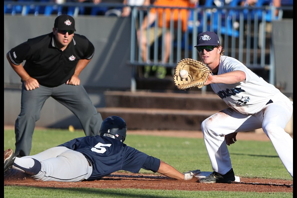 Sweets base runner Coby Kauhaahaa just gets a hand back ahead of the throw to HarbourCats first baseman Ben Polshuk during early action at Royal Athletic Park on Wednesday night.