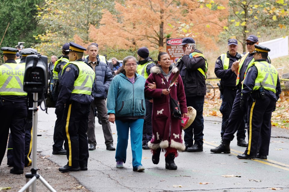 Clarissa Antone (left) crosses the police line at a Kinder Morgan protest in Nov. 2014. Antone is not happy with how the Woodfibre LNG and FortisBC projects have been handled by Squamish Nation leadership.
