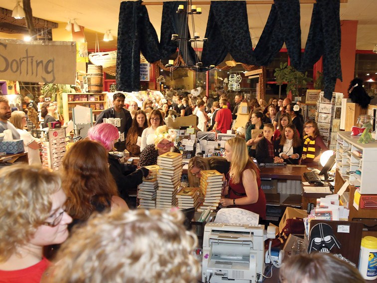 Books & Company staff work hard to hand out copies of Harry Potter and the Cursed Child on Saturday. The book was officially released at midnight and by 11:50 p.m. it was announced that all one hundred and twenty copies available at the bookstore had been sold. Citizen Photo by James Doyle July 30, 2016