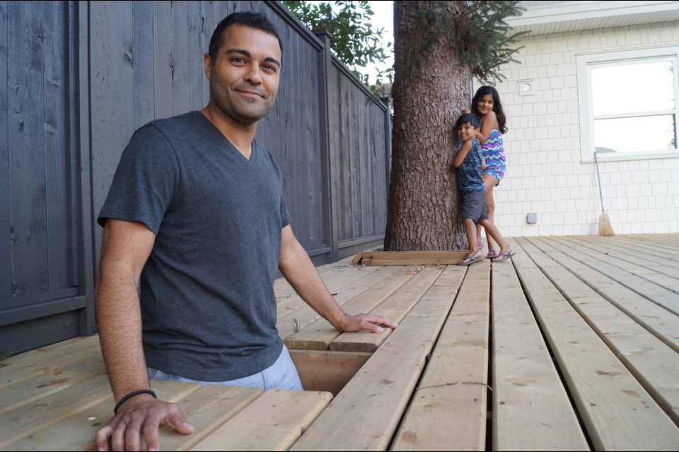 Steveston’s Rocky Sethi built an elevated deck at his new home to help preserve and protect a 70-foot-tall spruce on his property. His children like the fact they can see wildlife that make the tree their home, and he enjoys the shade it provides. Photo by Graeme Wood/Richmond News