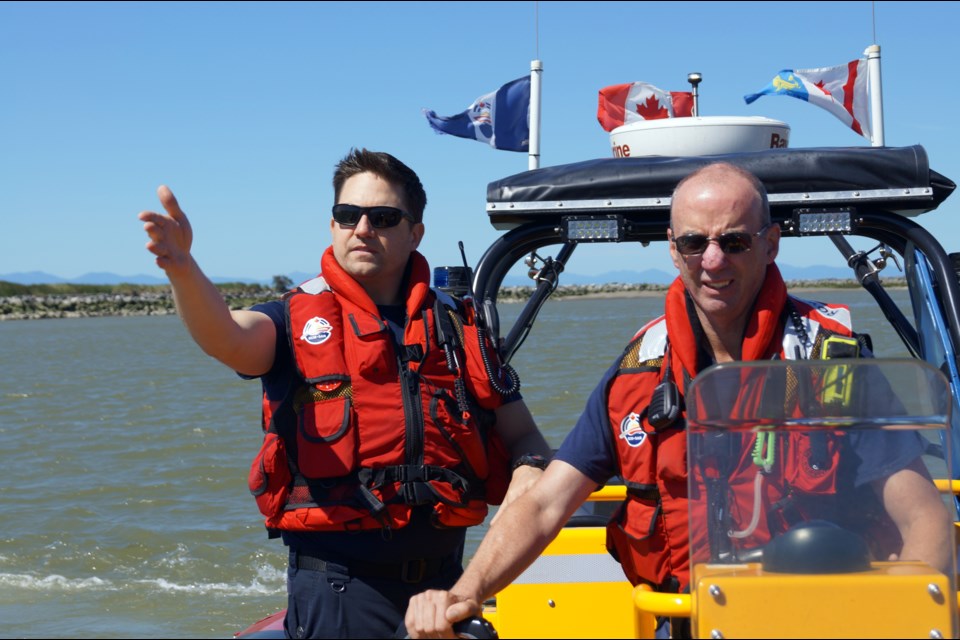 Volunteer search and rescue crew member, coxswain Kevin Robertson, left, leads advanced crew member Jim Heineky on a training exercise. The Royal Canadian Marine Search and Rescue team operates two boats on the river. Photo by Graeme Wood/Richmond News