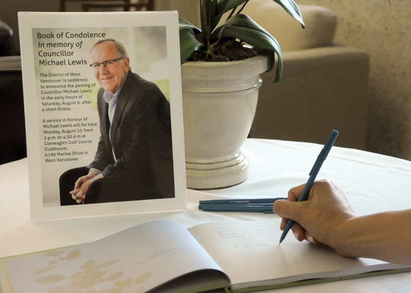 A District of West Vancouver staffer signs the condolence book set up in memory of Coun. Michael Lewis who died early Saturday morning. photo Mike Wakefield, North Shore News