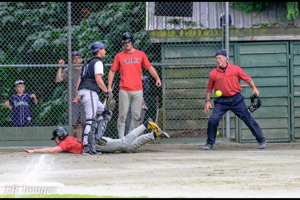 Umpire Colin Thompson calls Fireman Johnny Franklin safe at home, while Johnny’s teammate Malcolm McEachern and Shakers’ catcher Paul MacGillivray look on. The Firemen knocked out the Shakers in this semi-final game with a final score of 10-7.