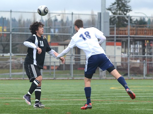 Windsor player #11 Rodrigo Miranda heads the ball.