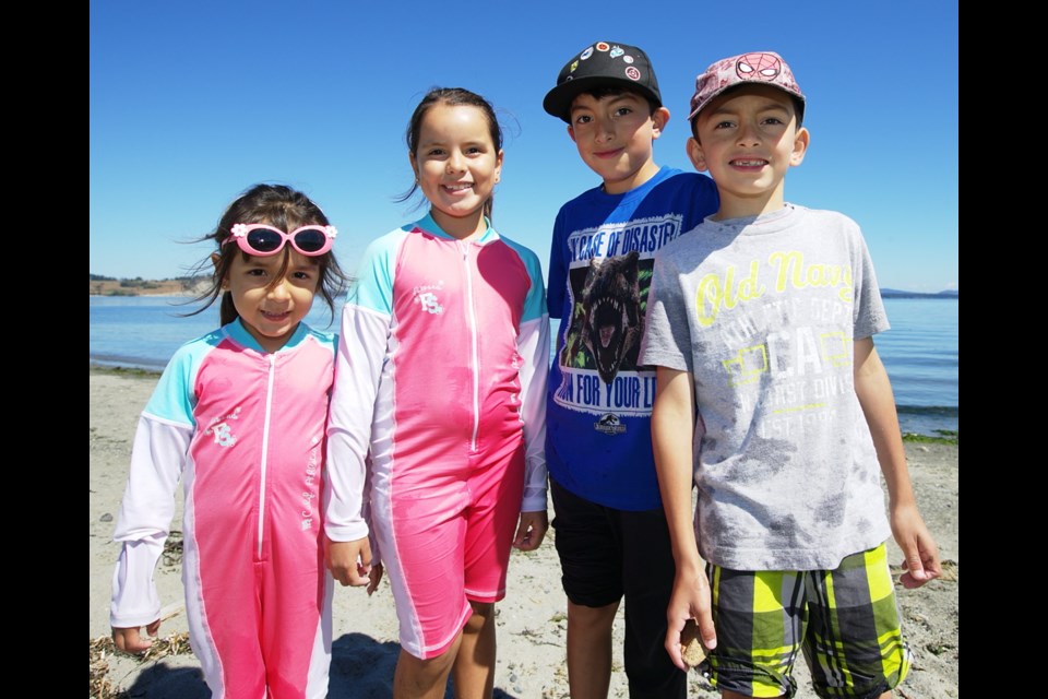 Danna Noguez, 6, Karla Noguez, 8, Erick Caraveo, 9, and Alan Caraveo, 7, soak up the sun.