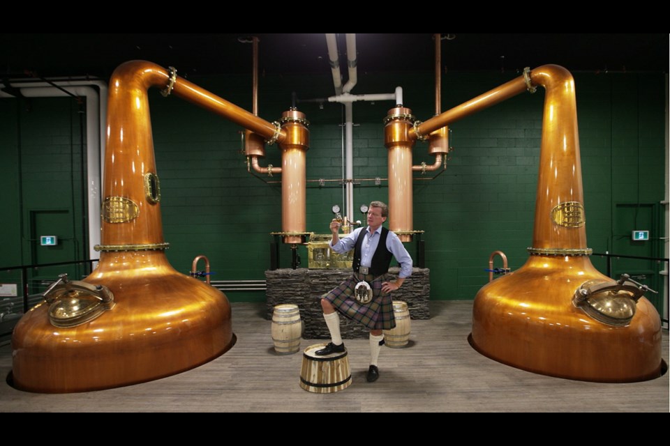 Graeme Macaloney, founder of Victoria Caledonian Distillery and Brewery, admires a glass of whisky from the two massive copper stills made for the new company at 761 Enterprise Crescent in Saanich. Manufactured by Forsyths, the stills were shipped from Speyside, Scotland, and arrived here March 17. The still on the left has a capacity of 5,500 litres and the still on the right has a capacity of 3,600 litres. Caledonian Distillery and Brewery opens for business and tours on Wednesday.