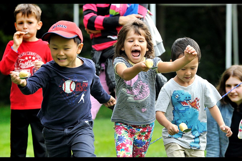 Mia Bosnic, 4 (centre), looks delighted in the potato-and-spoon race at the Burnaby Village Museum Labour Day Fair in 2014. The Labour Day Fair returns this year on Sept. 5.