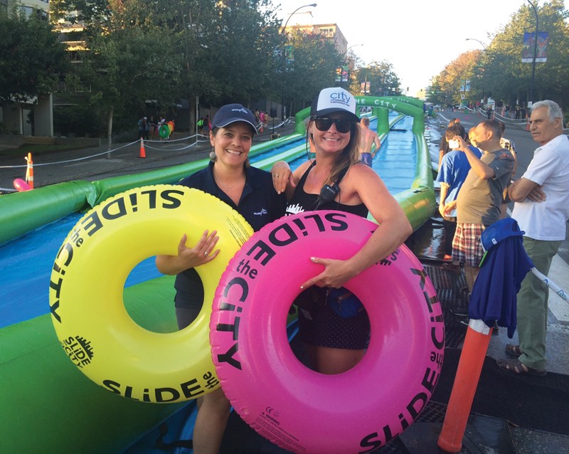 Juliana Buitenhuis (right), the city worker whose dreams helped bring Fun City Festival to life, braves Slide the City’s splash zone with Renate Sitch. photo supplied