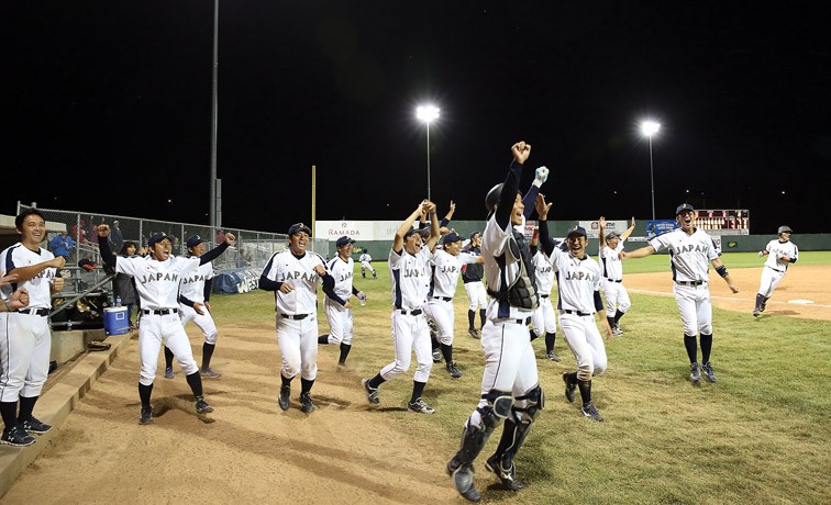 Players from Team Japan celebrate after defeating the Roswell Invaders in the gold-medal game of the Ramada World Baseball Challenge. Citizen Photo by James Doyle August 20, 2016