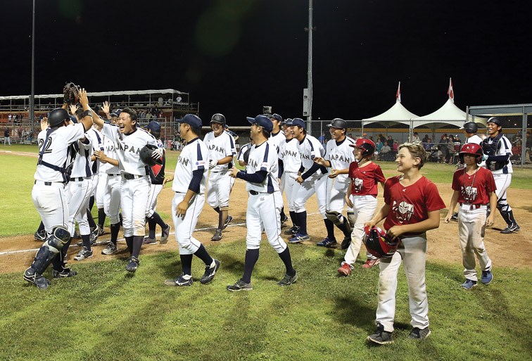 Players from Team Japan celebrate after defeating the Roswell Invaders in the gold-medal game of the Ramada World Baseball Challenge. Citizen Photo by James Doyle August 20, 2016