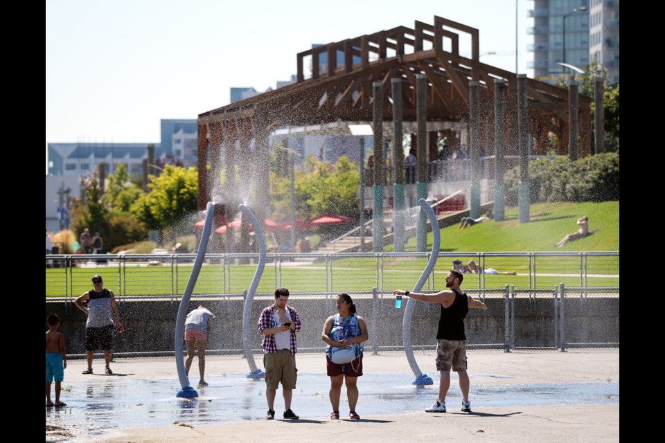 The misters at Pier Park offered a respite from Saturday's heat.