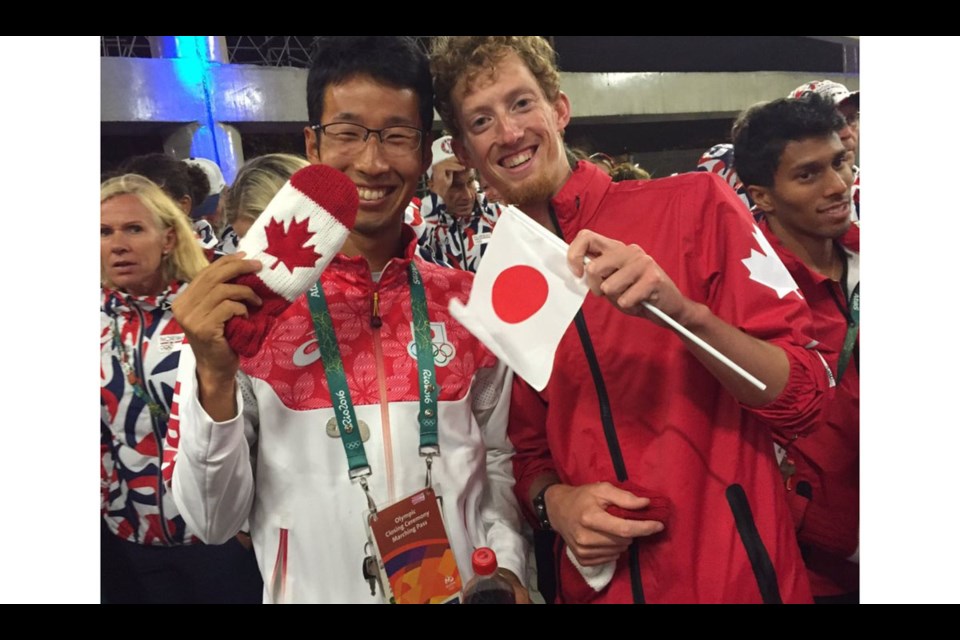 Richmond's Evan Dunfee shows what sportsmanship is all about after posing with Japanese race-walker Hirooki Arai. Dunfee has been promoted to the bronze medal position from fourth, after a race referee adjudged Arai had fouled the Richmond athlete near the end of the 50K race. A Japanese appeal was later upheld and Arai was reinstated to third place.