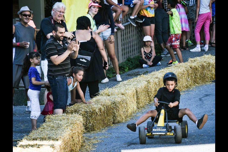 Adults and children raced in Friday’s third annual Ray-Cam Soapbox Derby. The racetrack was in the alley behind Ray-Cam Co-operative Centre and was organized in partnership with the Vancouver Police Department. The soapbox racers are built by youth in the NASKARZ program at Vancouver Community College.