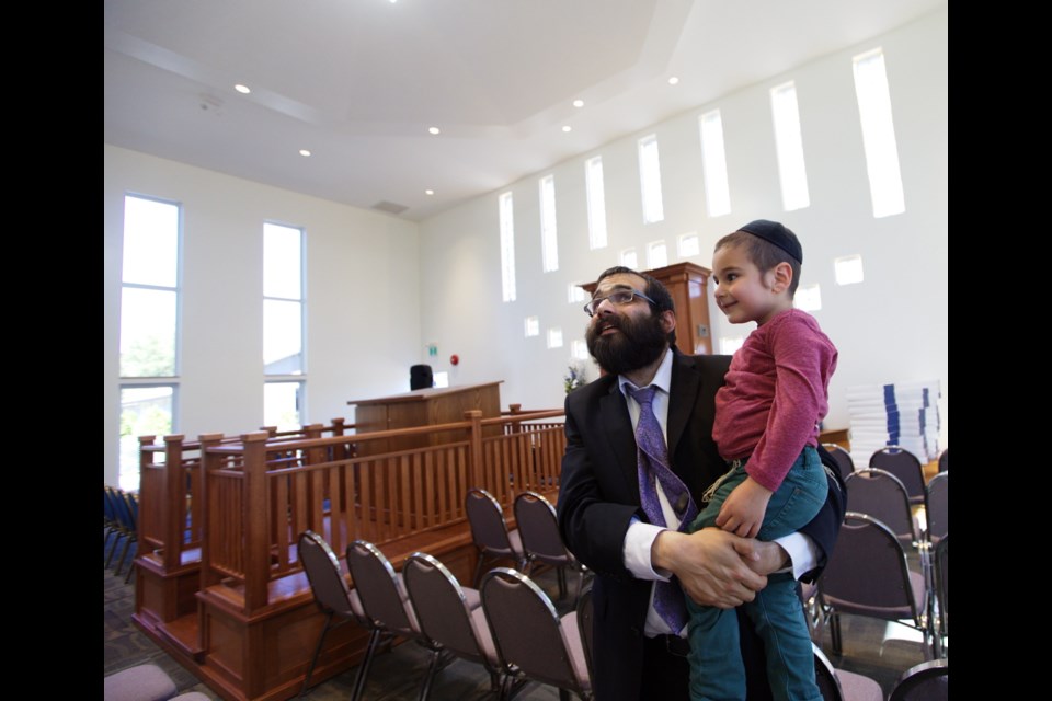 Rabbi Meir Kaplan and his three-year-old son, Sholom Ber Kaplan, check out the new Chabad Centre for Jewish Life and Learning on Glasgow Street, near Topaz Park, in Victoria on Wednesday.