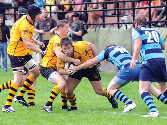 Capilano ball carrier runs into Bayside opposition.