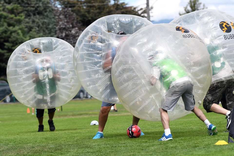 Having a ball: The Last Door Recovery Society’s annual sports day in Moody Park featured challenging activities like ancient war games, human foosball and a Tough Mudder styled obstacle course. Here, men and women compete in bubble ball, which one participant described as being like an aggressive type of soccer – while clad in a bubble.