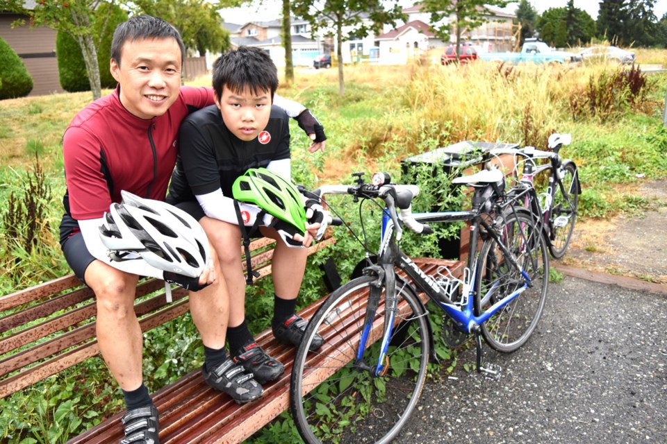 John Huang (left) and his son Leo embarked on an ambitious cycling trek from Richmond to Edmonton this summer. Photo by Philip Raphael/Richmond News