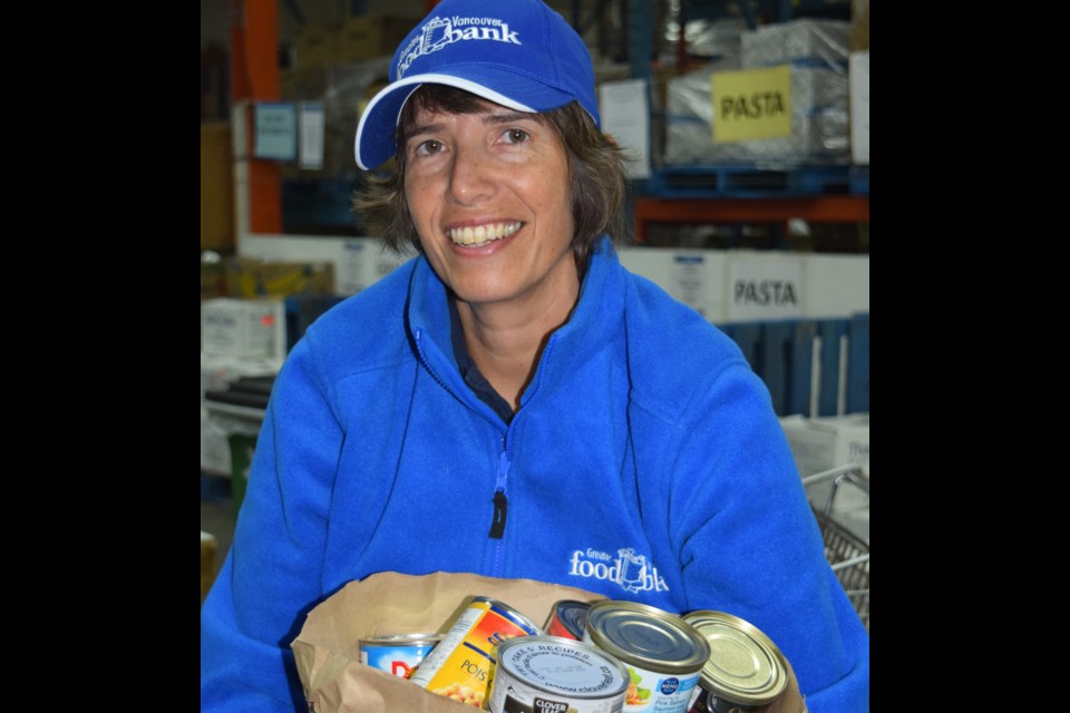 Ariela Friedmann, director of communications with the Greater Vancouver Food Bank, with one of the donation bags from the citywide food drive.
